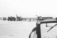 Me109_fighter_planes_being_refueled_on_airfield