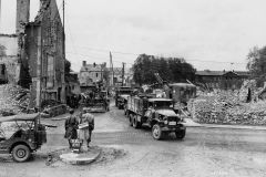 1055th_Engineers_Clear_Rubble_in_Isigny_France_with_Gas_Shovel_Trucks_Dozer