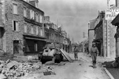 35th_Infantry_Division_Troops_And_Wrecked_Flakpanzer_38t_In_Tessy_Sur_Vire_France
