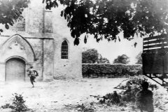 Airborne_Trooper_runs_for_sniper_hiding_in_Church_in_St_Mere_Eglise