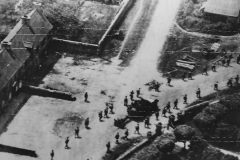 American_soldiers_file_thru_St._Jacques_De_Nehou_enroute_to_Barneville_and_Carteret_Normandy