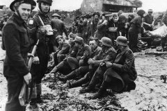 Canadian_troops_guard_German_POW_on_D-Days_Juno_Beach