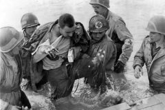 Medics_Help_Wounded_US_Paratrooper_D-Day_Beach_1944_Normandy