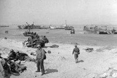 Scene_on_one_of_the_invasion_beache_during_force_buildup_operations_in_June_1944