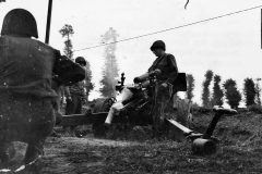 US_105_mm_Howitzer_Crew_in_Action_Normandy_July_1944