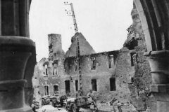 US_Army_Soldiers_and_Vehicles_Move_through_St._Giles_Normandy_France_July_1944