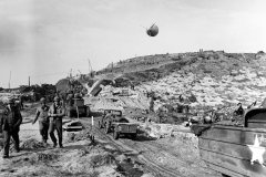 US_Army_vehicles_move_inland_on_Omaha_Beach_during_the_early_days_of_the_invasion
