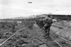US_Infantrymen_Advance_thru_German_Minefield_in_Normandy_1944