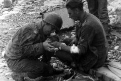 US_Medical_Officer_treats_wounded_German_on_Normandy_Beach