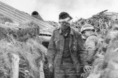 Wounded_German_Prisoner_with_MP_of_1st_ESB_449th_MP_Co_in_Normandy