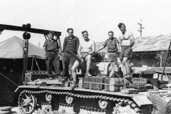 Crew_work_on_a_Panzer_III_tank_in_a_workshop