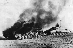 Crusader_tank_passing_a_burning_Panzer_IV_during_Operation_Crusader_in_Libya_1941