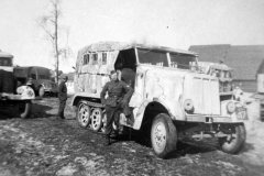 Wehrmacht_soldiers_standing_next_to_a_SdKfz_6